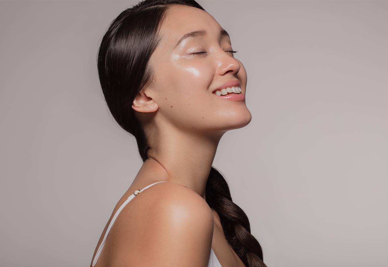 Woman smiling with bright and shiny skin