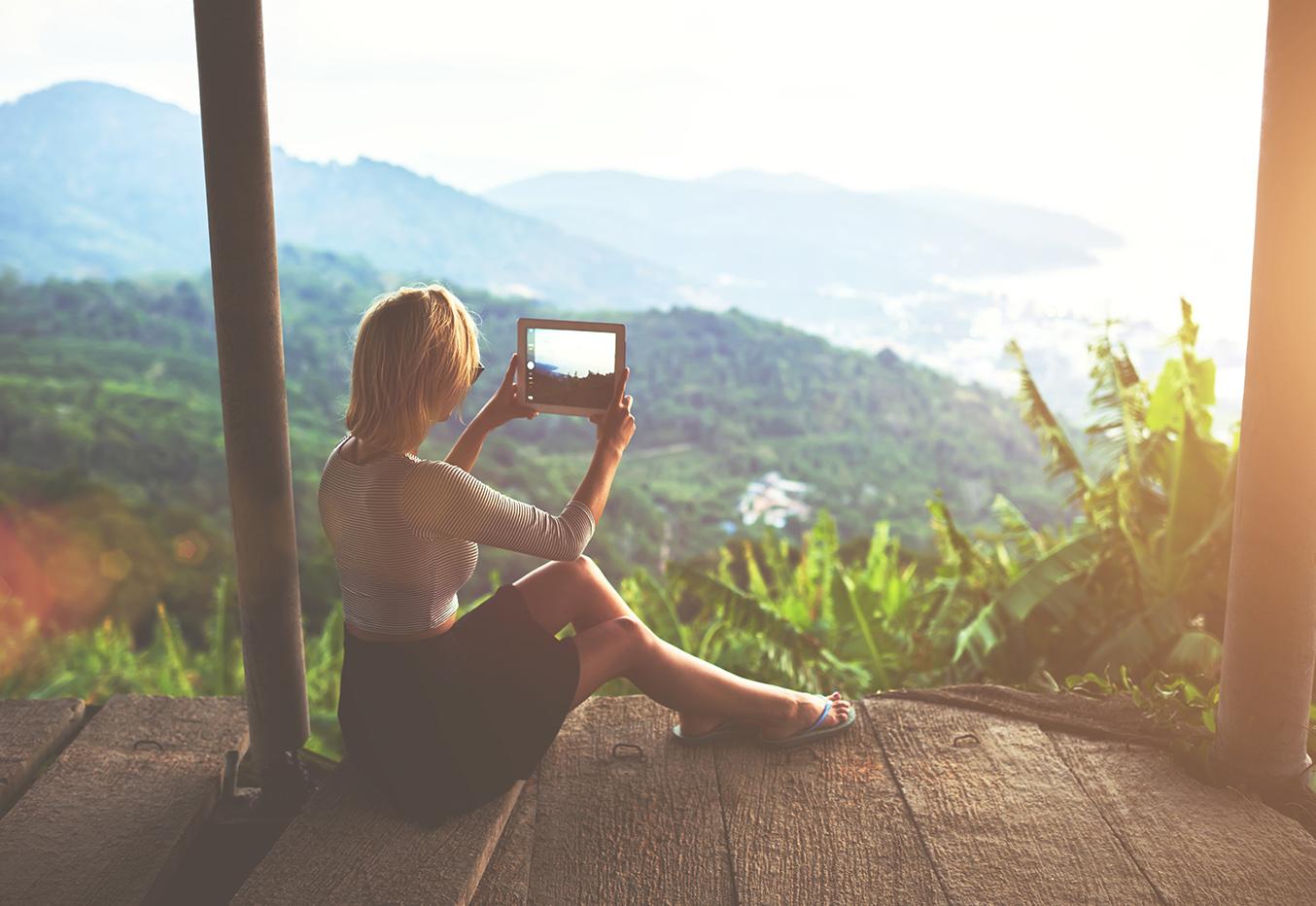 girl traveling holding ipad