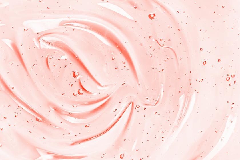 Beauty serum gel texture. Pink clear skincare cream with bubbles background. Transparent colored cosmetic product close up